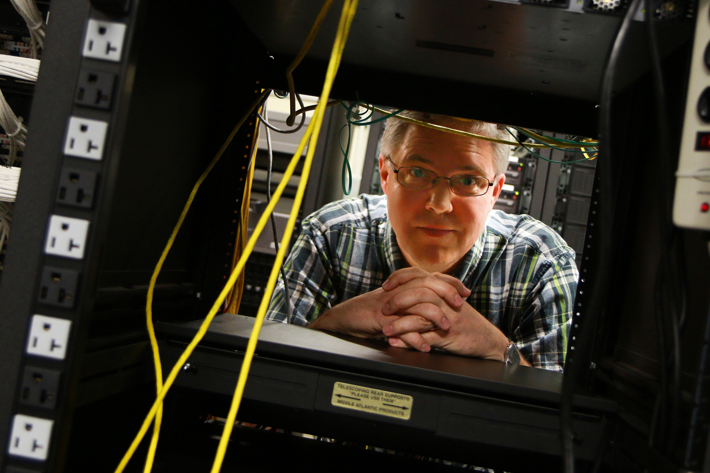 Eric Eide, University of Utah research assistant professor of computer science, stands in the computer science department's "Machine Room" where racks of web servers sit. It is on these computers that Eide, U computer science associate professor John Regehr, and their research team created and tested A3, a suite of computer applications that defeat malware and automatically repair the damage it causes. The project could help lead to better consumer software defenses.