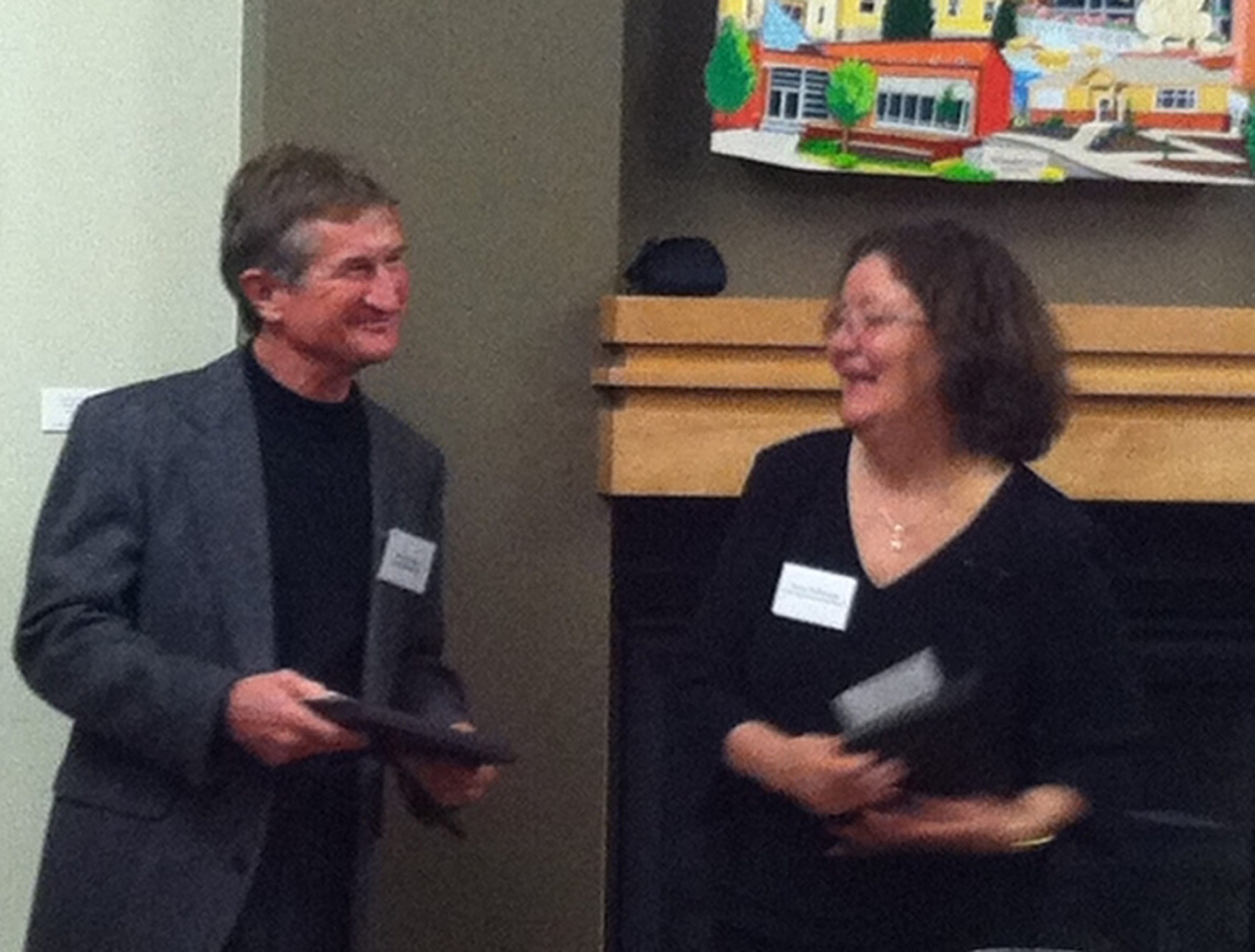 Steven Simms accepting the award from Ronni McDonough, co-chair of the Utah Book Award.