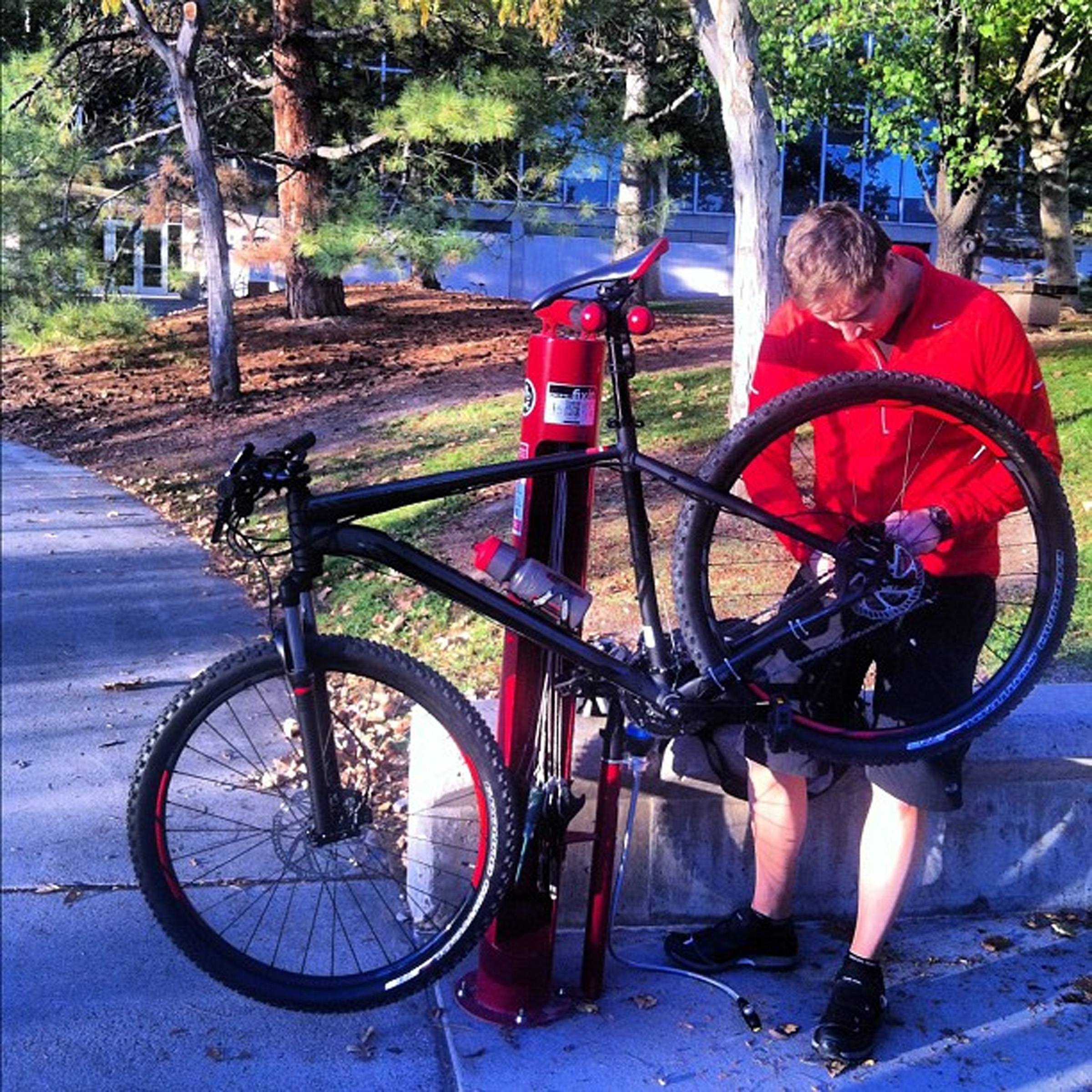 Bicycle rider at the University of Utah at one of the bicycle repair stations across campus.