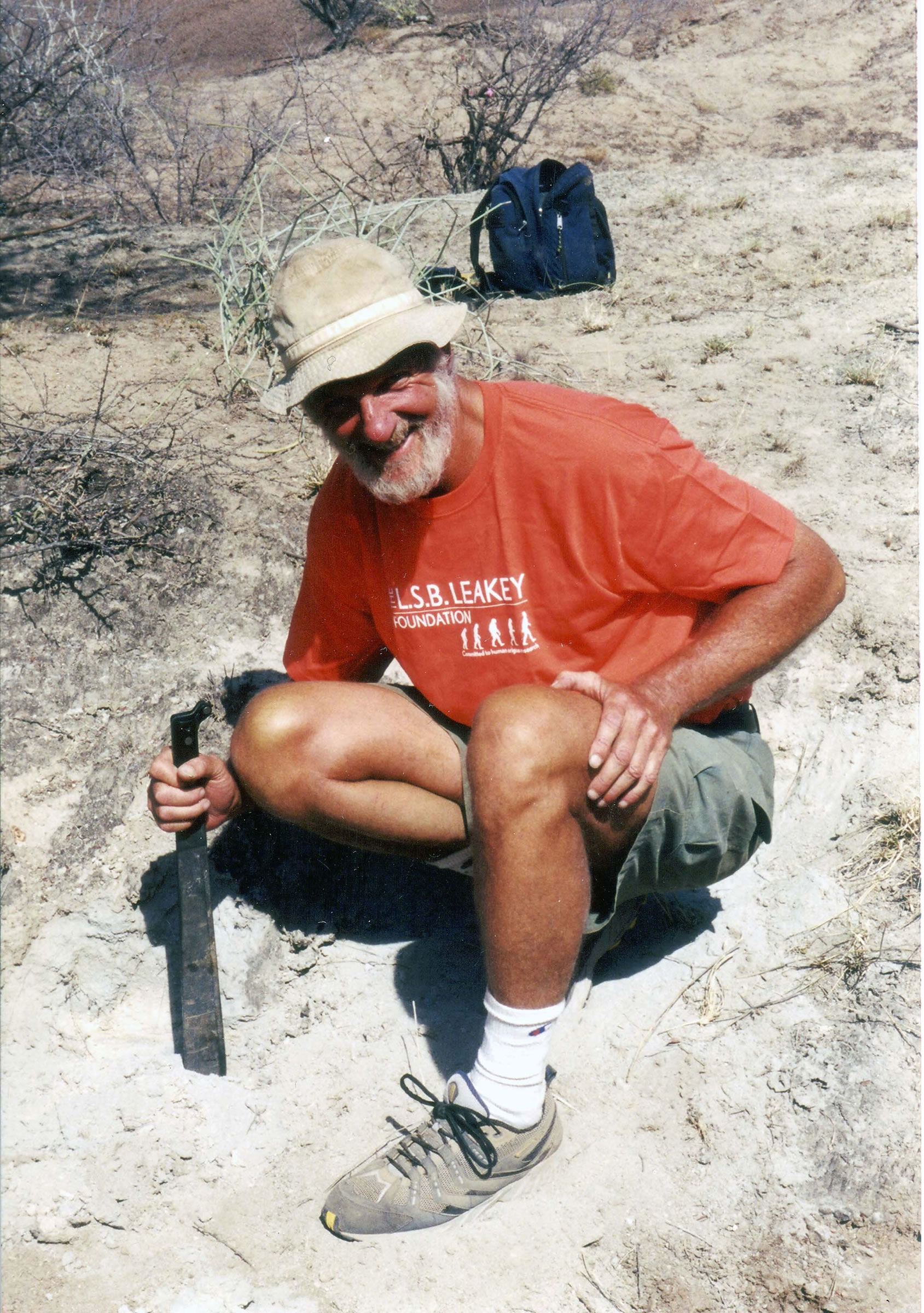 Geologist Frank Brown, dean of mines and Earth sciences at the University of Utah, crouches on Ethiopia's Kibish rock formation, where Brown and colleagues determined that fossilized bones of Homo sapiens were 195,000 years old -- the oldest fossils of the our species ever found.