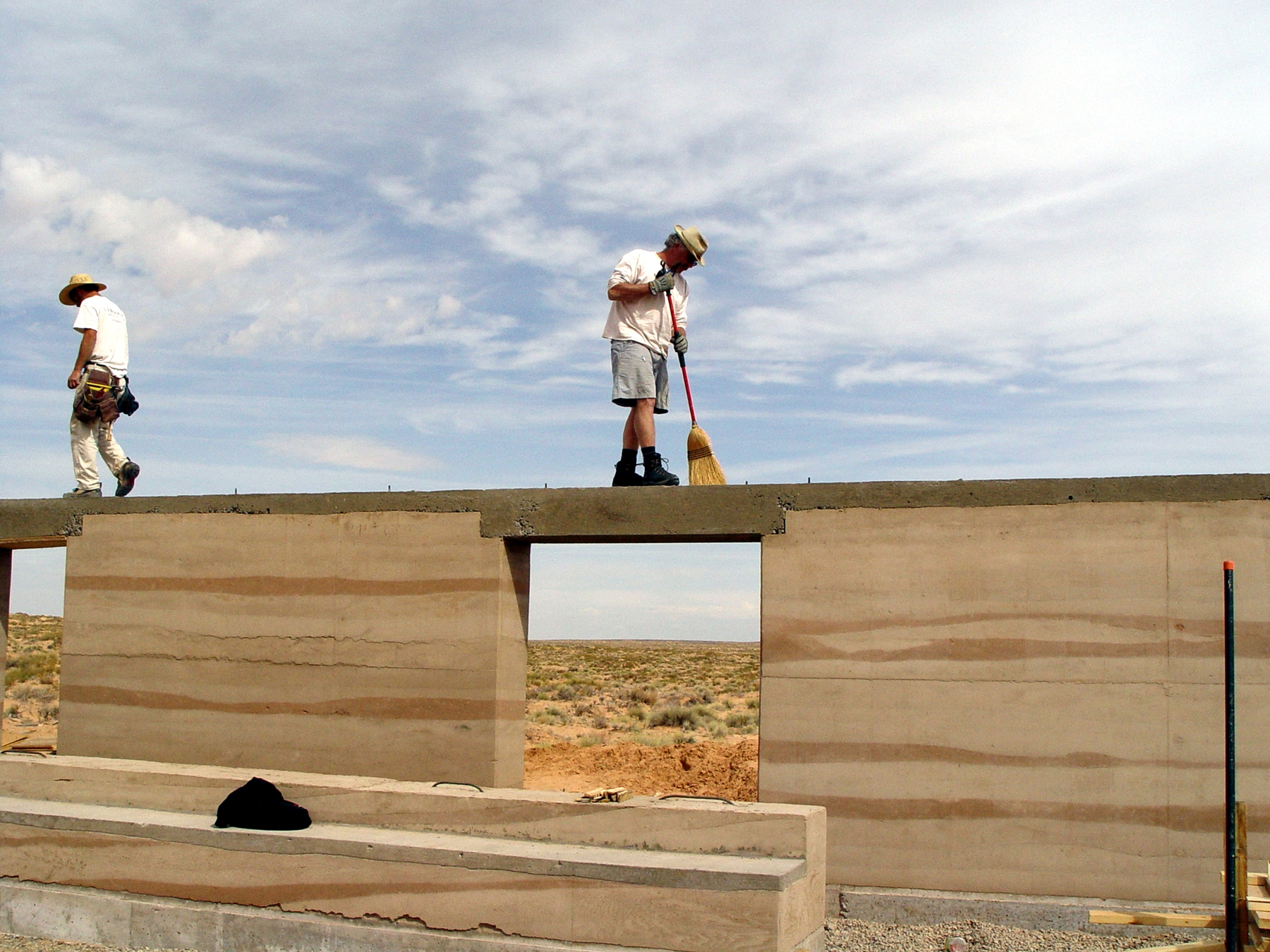 Hank Louis and architecture graduate student work on rammed earth home in Bluff, Utah.