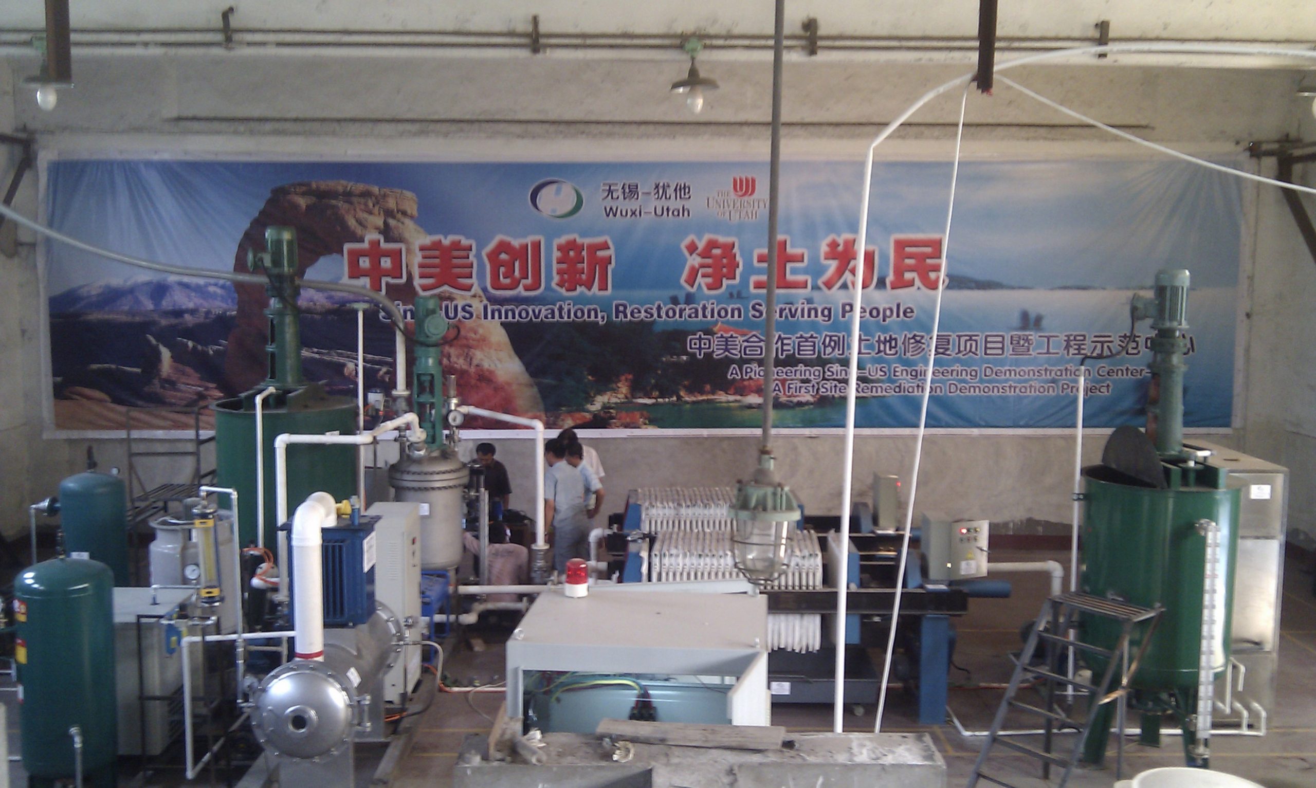 University of Utah civil and environmental engineer Andy Hong has teamed up with Chinese environmental cleanup company Honde LLC to use Hong's method of heightened ozonation treatment or HOT to clean metals and other contaminants from polluted soil along the shores of Lake Taihu near Wuxi, China. The treatment system at Lake Taihu is shown in this photo. The HOT reactor or vessel where ozone treatment occurs is the vertical, silver-colored tank left of center. It is an essential component in the treatment system that also includes an ozone generator, compressor, air tank, green mixing tanks, press filter and plumbing.