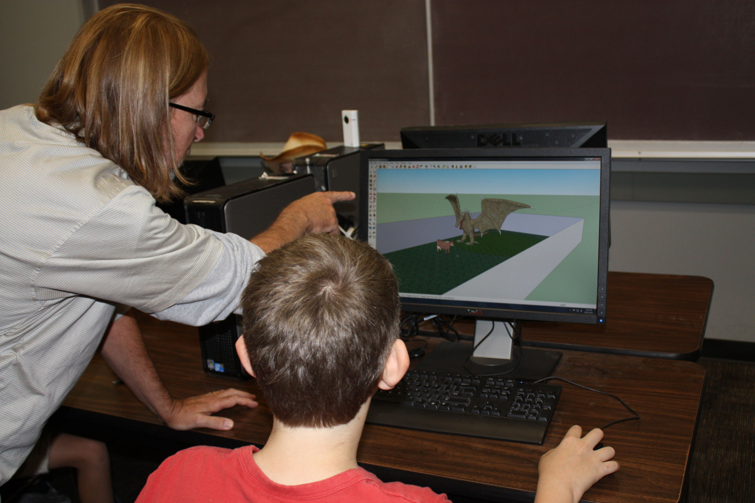 Steve Gross, certified SketchUp instructor, helps student tap into the technology at an iSTAR workshop for kids on the autism spectrum. Researchers found that for grandparents involved with their grandchildren in the workshops, new communication doors were opened between them.