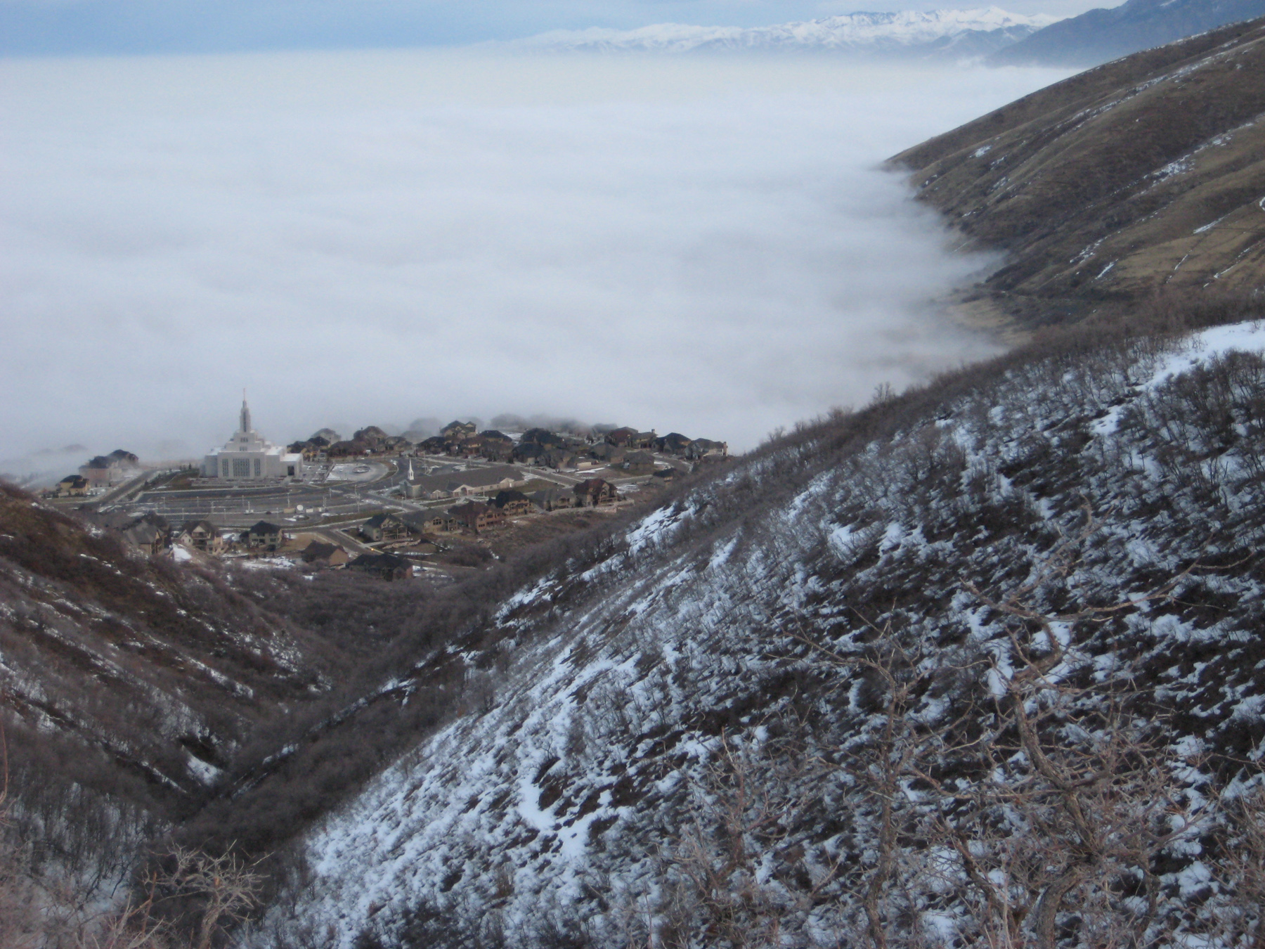 Polluted air in the Salt Lake Valley often is capped by fog, as is the case in this image of a temperature inversion holding cold, smoggy air close to the ground, just below the level of the Mormon church temple in Draper, Utah. University of Utah meteorologists are wrapping up two months of field measurements as part of a three-year, National Science Foundation-funded study of inversions and the weather conditions that promote them.